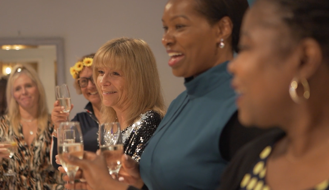 Women celebrating together with a glass of champagne
